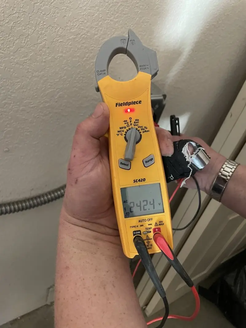 Voltage testing with clamp meter during Electrical Installation Services in Keokuk